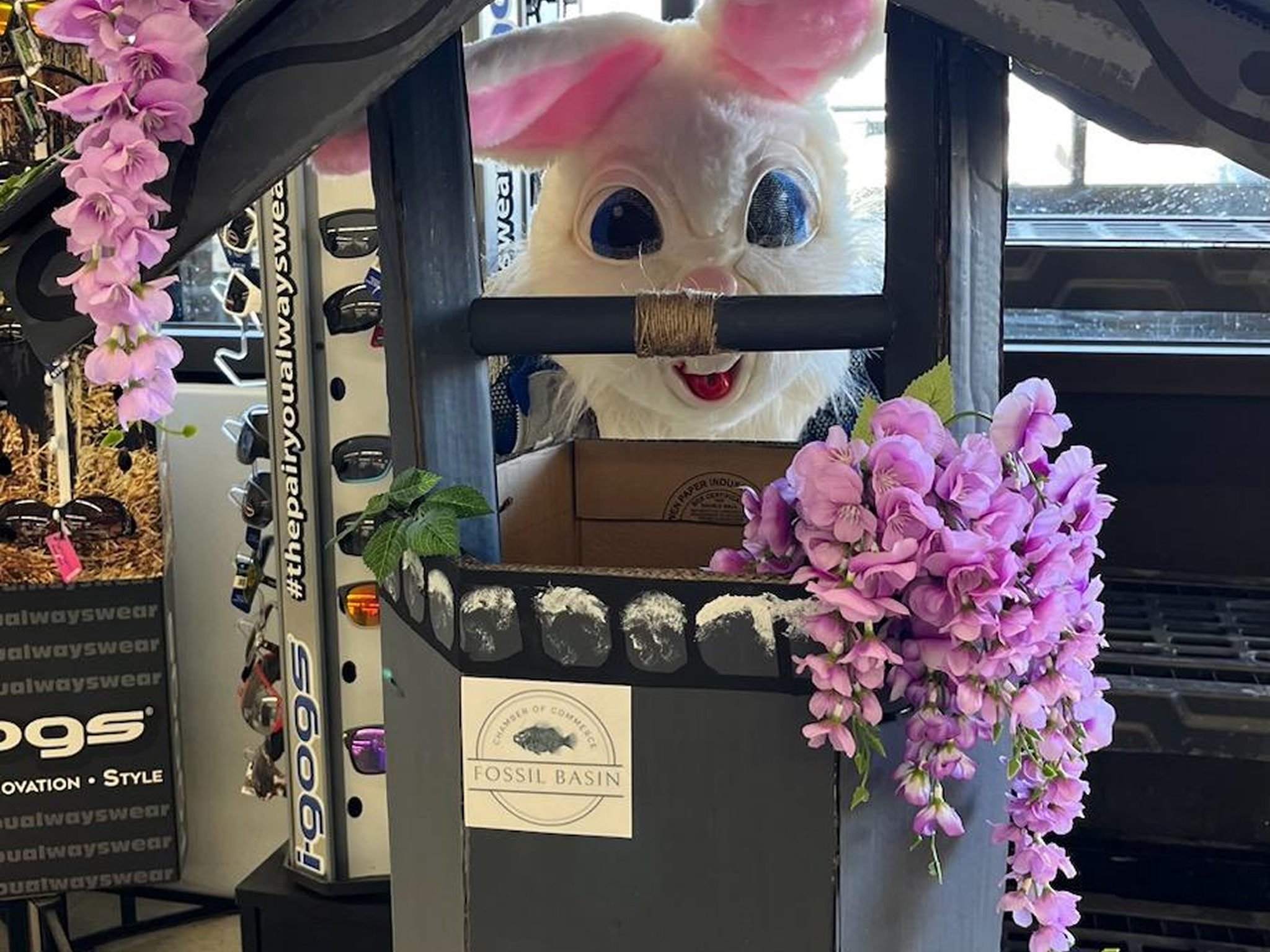 Easter bunny costume in decorated wooden structure.